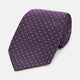 The Turnbull & Asser Lilac and Purple Micro Dot Silk Tie, featuring a subtle white micro-dot pattern, is rolled up and displayed on a white background—an essential addition to any polished wardrobe.