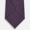 View 3 of product The Turnbull & Asser Lilac and Purple Micro Dot Silk Tie, featuring a subtle white micro-dot pattern, is rolled up and displayed on a white background—an essential addition to any polished wardrobe.