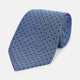 The Turnbull & Asser Navy and Blue Micro Dot Silk Tie is shown rolled up, featuring a steel blue color with small navy blue dots, on a plain white background.
