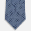 View 3 of product The Turnbull & Asser Navy and Blue Micro Dot Silk Tie is shown rolled up, featuring a steel blue color with small navy blue dots, on a plain white background.