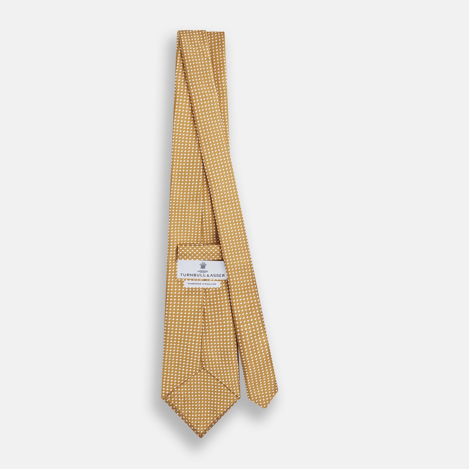 View 3 of product A Turnbull & Asser Light Brown and White Diamond Silk Tie, featuring a refined white geometric pattern, ideal for modern office wear, shown rolled on a plain white background.