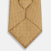 View 4 of product A Turnbull & Asser Light Brown and White Diamond Silk Tie, featuring a refined white geometric pattern, ideal for modern office wear, shown rolled on a plain white background.