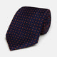A Navy and Orange Circle Silk Tie by Turnbull & Asser, neatly rolled on a white background.