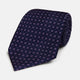 The Navy and Lilac Circle Silk Tie by Turnbull & Asser features pink and purple circles on dark navy silk, shown rolled on a white background—ideal for formal occasions.