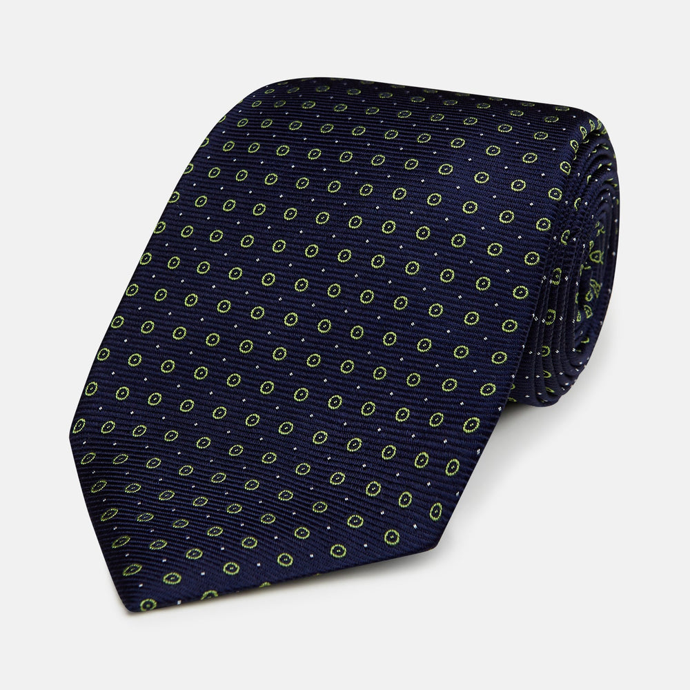 The Turnbull & Asser Navy and Light Green Circle Silk Tie features a navy base with small light green circular patterns, crafted from fine silk.
