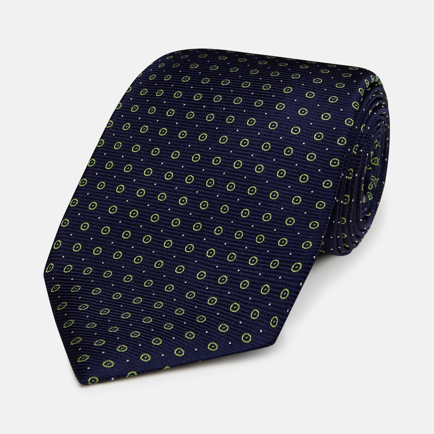 View 1 of product The Turnbull & Asser Navy and Light Green Circle Silk Tie features a navy base with small light green circular patterns, crafted from fine silk.