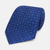 View 1 of product The Turnbull & Asser Blue Multi Dot Silk Tie features a rolled-up blue design with small light blue dots, offering an elegant, refined accent to office attire.