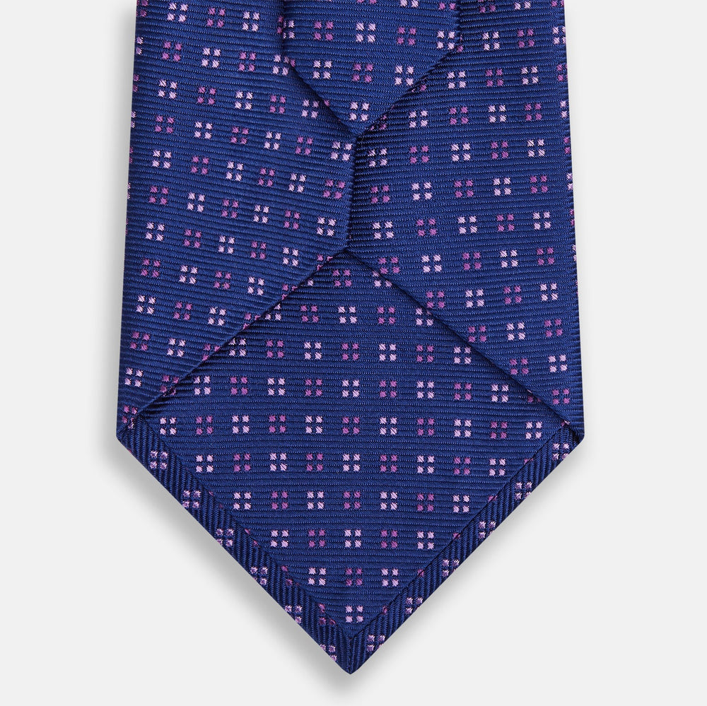 The Turnbull & Asser Blue and Pink Multi Dot Silk Tie, featuring a refined dot pattern, is displayed on a white background—an elegant accessory perfect for modern office style.