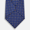 View 3 of product The Turnbull & Asser Blue and Yellow Multi Dot Silk Tie features a geometric yellow and white pattern, ideal for modern office wear. The elegant silk tie is showcased rolled up on a plain white background.