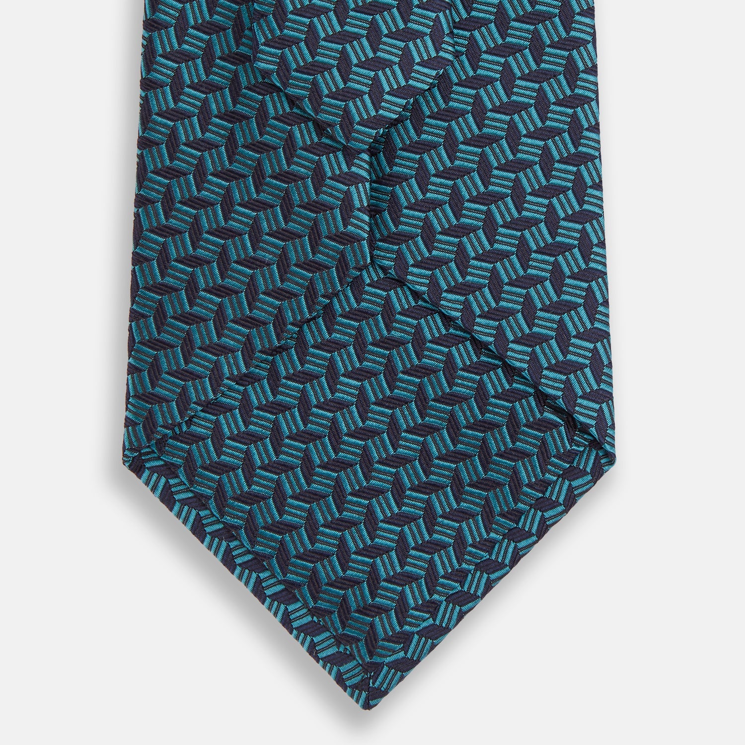 View 3 of product The Turnbull & Asser Turquoise Geometric Silk Tie features interlocking blue and teal cubes for a 3D effect, offering British elegance. Shown rolled up on a plain white background.