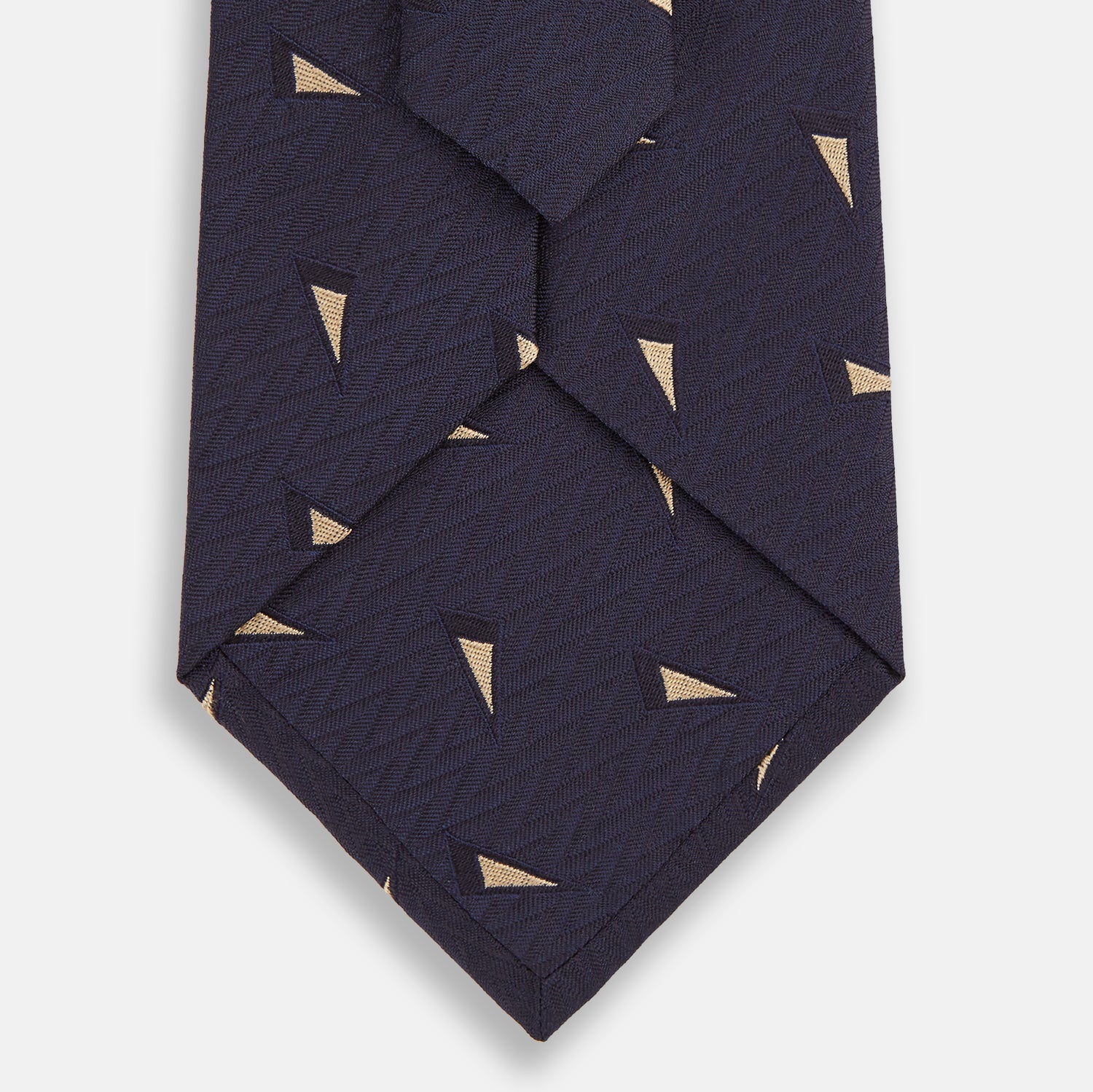 View 3 of product The Navy Triangle Silk Tie by Turnbull & Asser features an elegant gold micro triangle pattern on navy silk, making it a sophisticated accessory that pairs perfectly with Turnbull & Asser shirts.