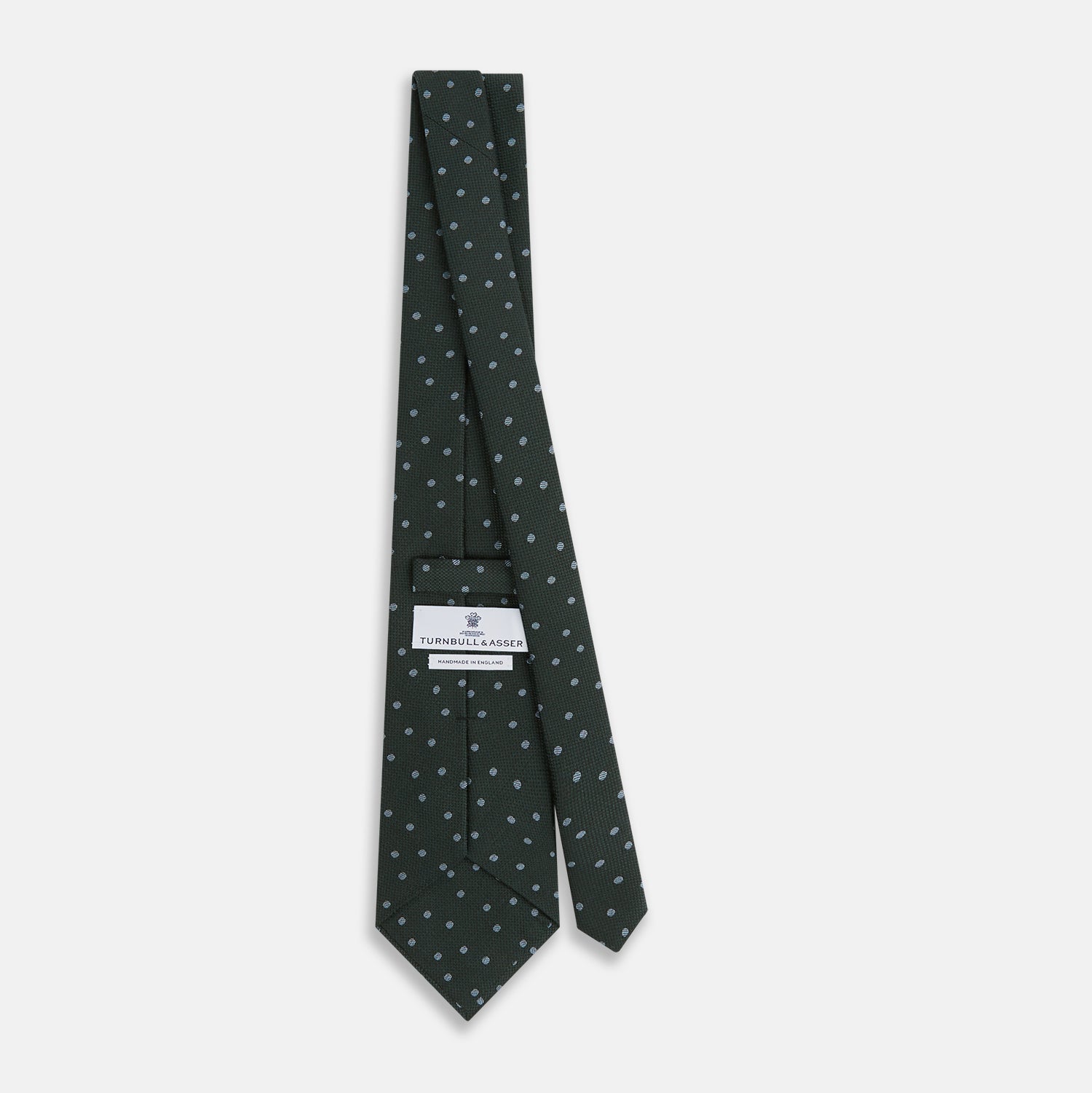 View 4 of product The Turnbull & Asser Pale Blue and Green Micro Dot Silk Blend Tie, shown rolled on a white background, is ideal for complementing your favorite shirts.