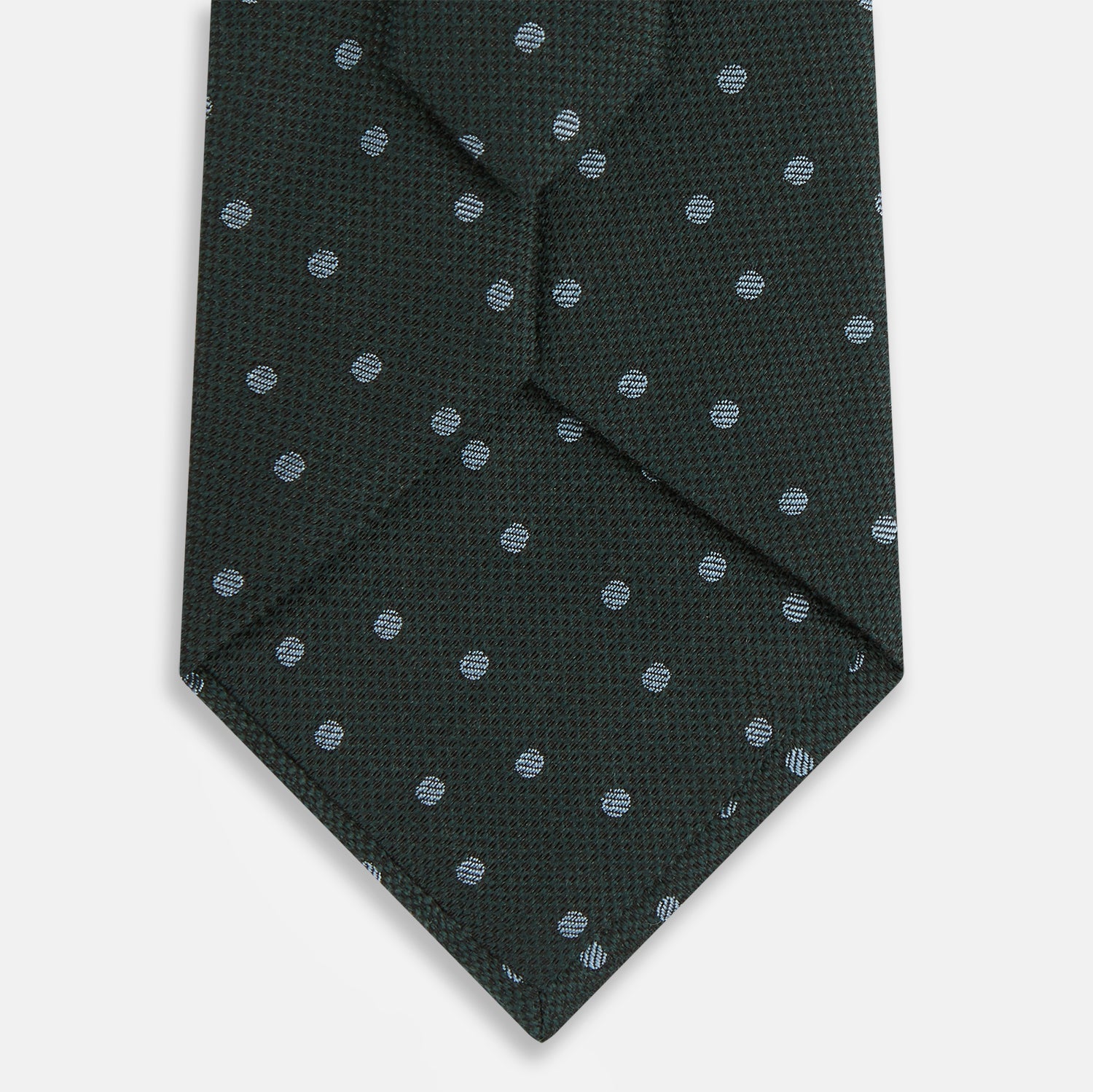View 3 of product The Turnbull & Asser Pale Blue and Green Micro Dot Silk Blend Tie, shown rolled on a white background, is ideal for complementing your favorite shirts.