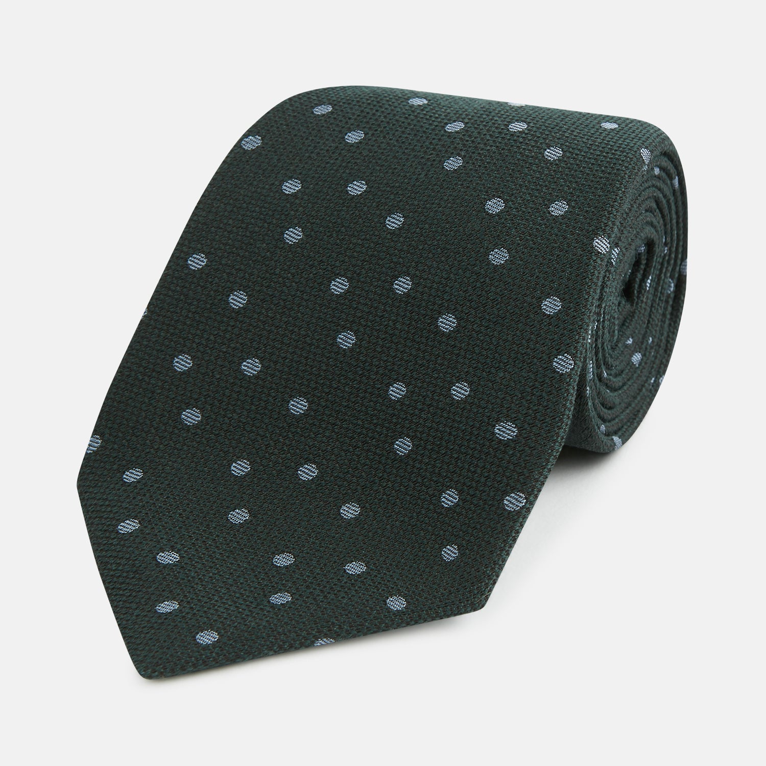View 1 of product The Turnbull & Asser Pale Blue and Green Micro Dot Silk Blend Tie, shown rolled on a white background, is ideal for complementing your favorite shirts.