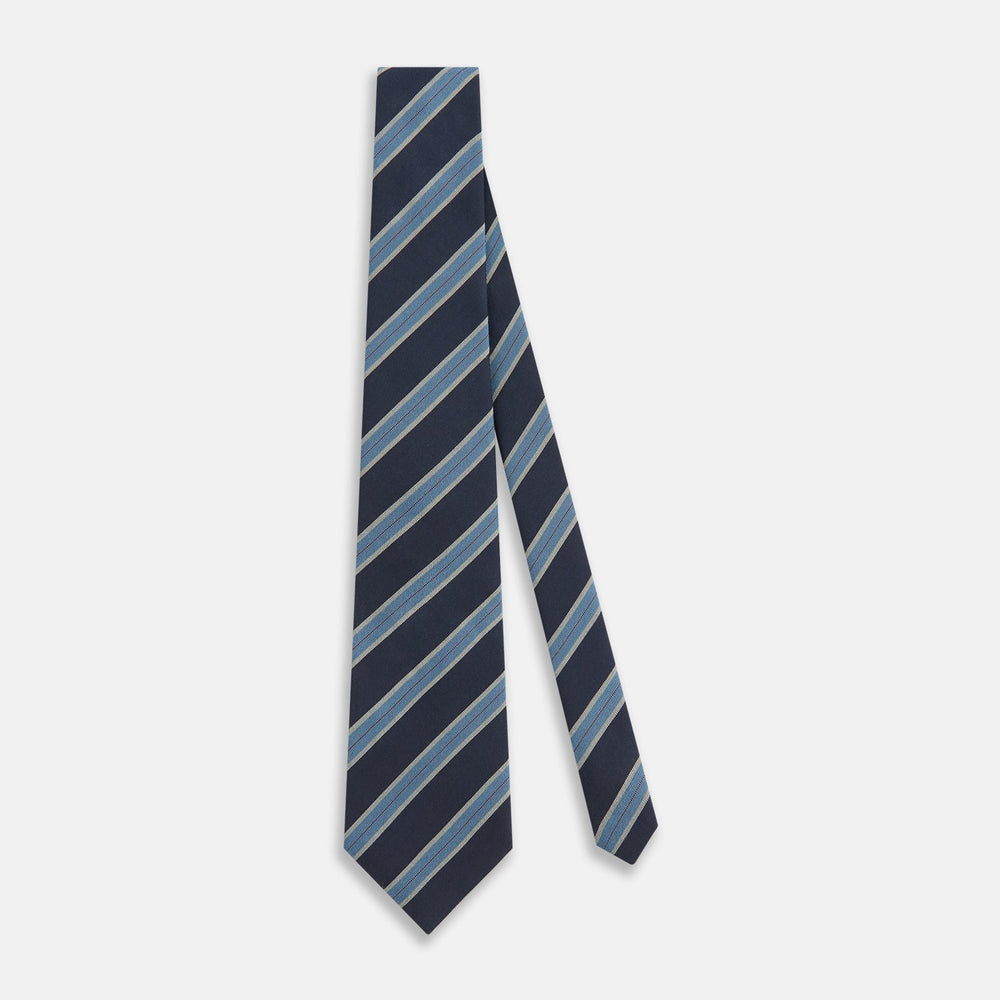 The Turnbull & Asser Blue Multi Stripe Silk Blend Tie features navy, light blue, and silver diagonal stripes and is displayed rolled up on a white background. An ideal pairing with Turnbull & Asser shirts.