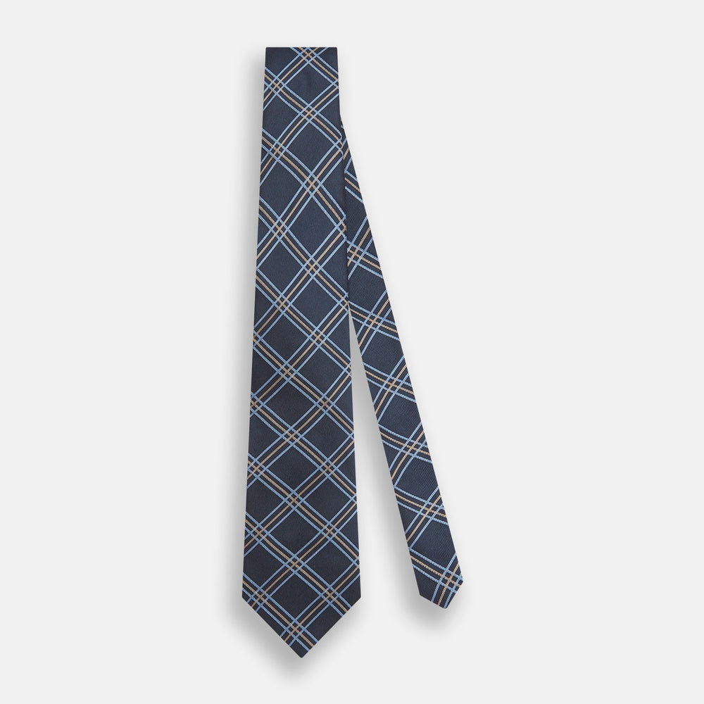 The Turnbull & Asser Navy Triple Check Silk Tie features a light blue and white plaid pattern—an essential accessory for the modern gentleman and a perfect complement to any Turnbull & Asser shirt.