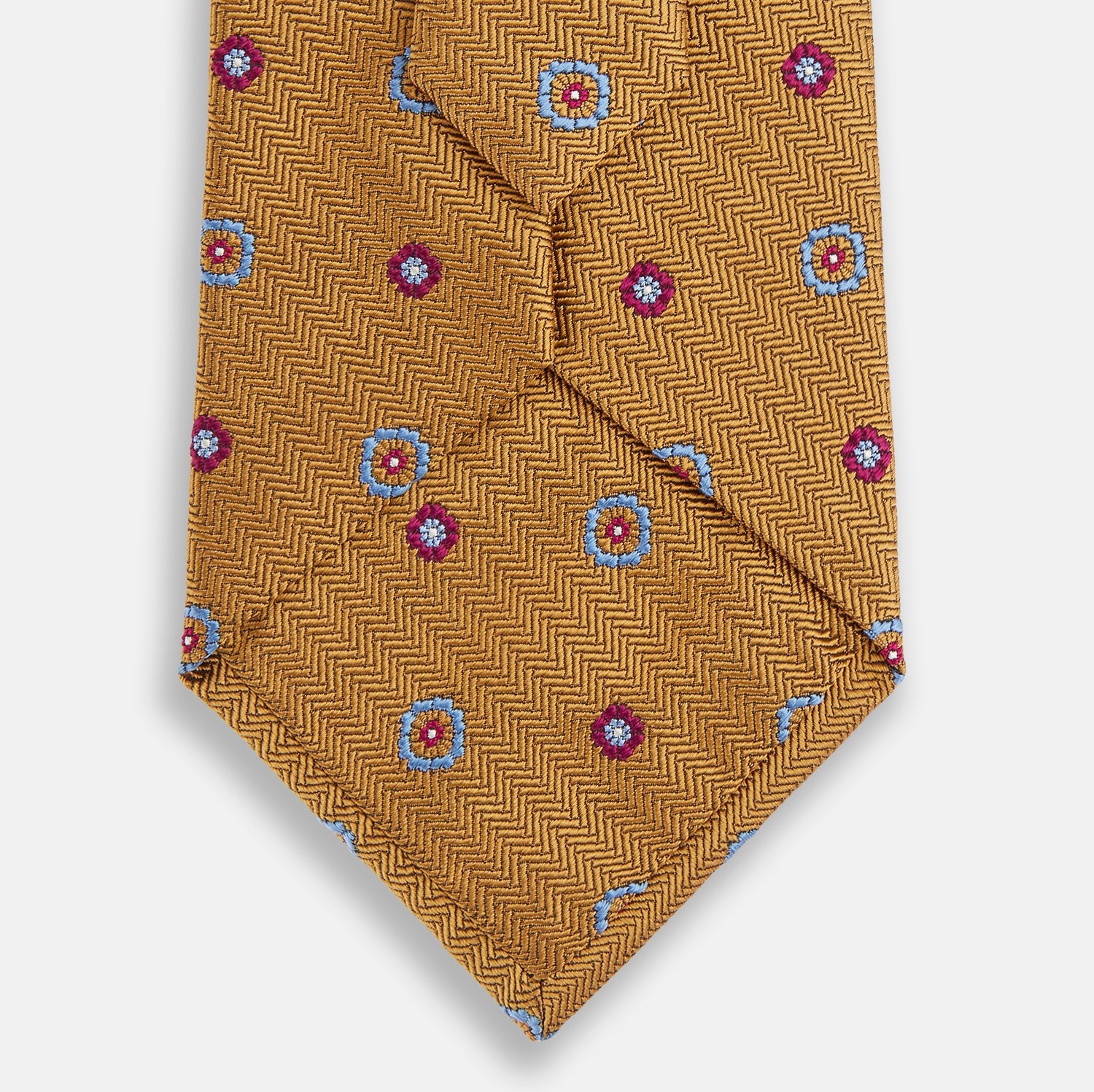 View 3 of product The Gold Motif Silk Tie by Turnbull & Asser features a refined yellow herringbone texture with blue and red floral accents, capturing British elegance—a sophisticated addition to any discriminating wardrobe.