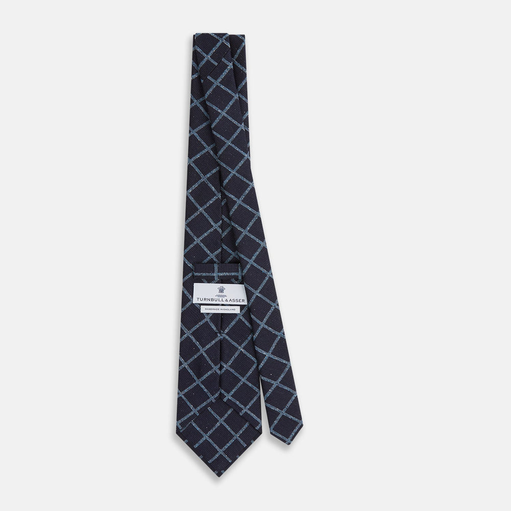 The Blue Diagonal Check Silk Blend Tie by Turnbull & Asser features a navy and light blue check pattern—a crisp accent for your favorite shirts.