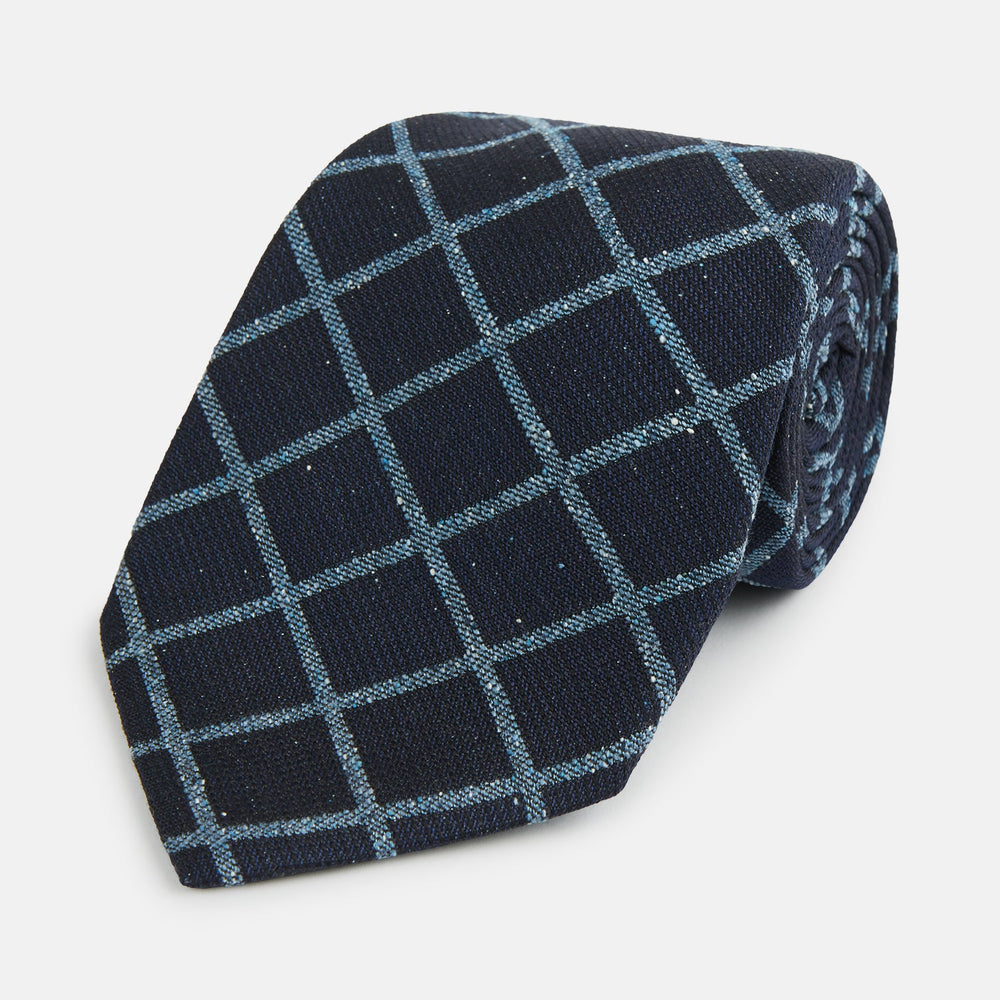 The Blue Diagonal Check Silk Blend Tie by Turnbull & Asser features a navy and light blue check pattern—a crisp accent for your favorite shirts.