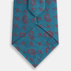 View 3 of product The Teal Paisley Silk Tie by Turnbull & Asser features a red paisley and small floral pattern, shown rolled with the pointed end forward on a white background.