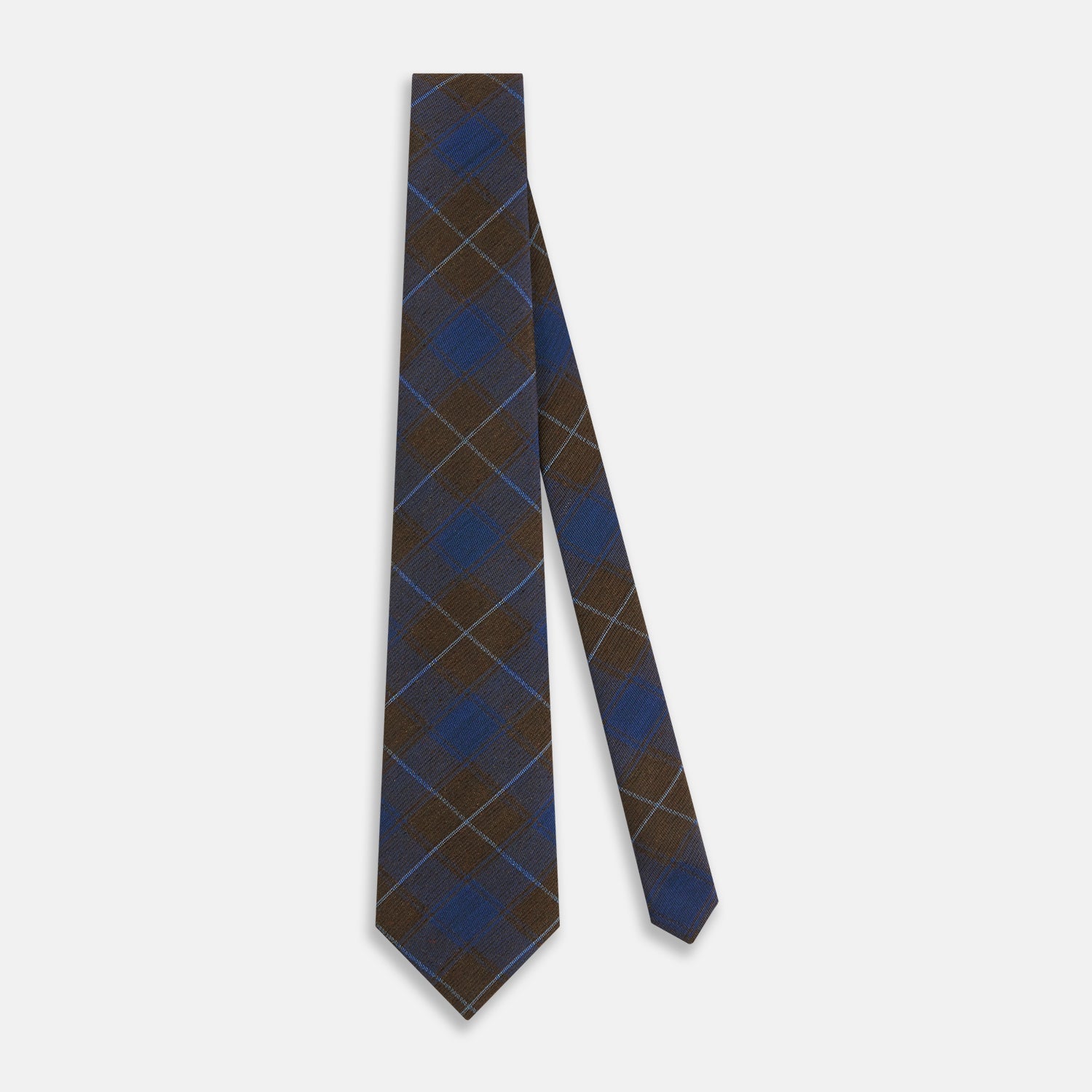 View 2 of product The Turnbull & Asser Blue and Brown Tartan Silk Blend Tie, rolled up to show intersecting patterns, is displayed against a plain white background.