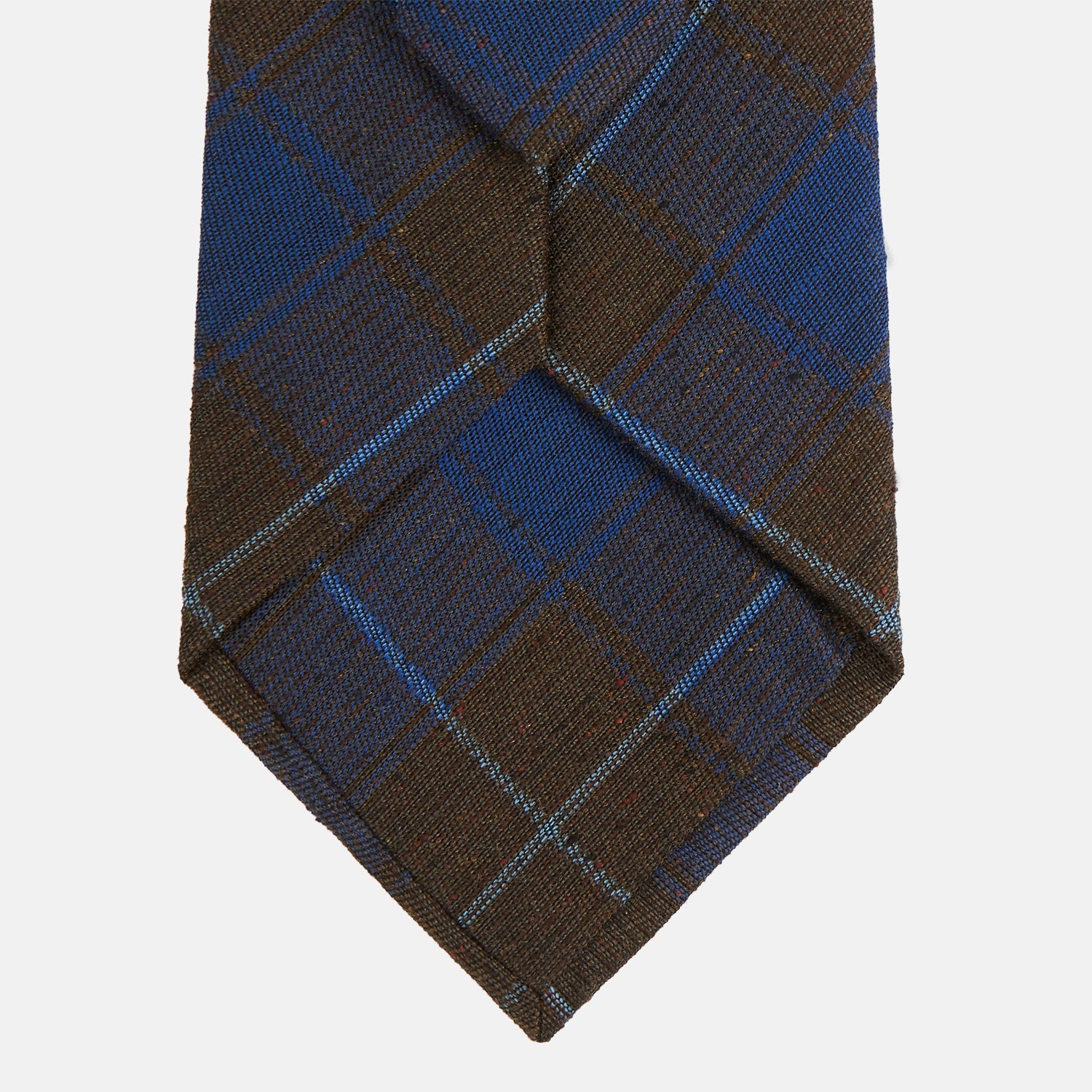 View 3 of product The Turnbull & Asser Blue and Brown Tartan Silk Blend Tie, rolled up to show intersecting patterns, is displayed against a plain white background.