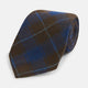 The Turnbull & Asser Blue and Brown Tartan Silk Blend Tie, rolled up to show intersecting patterns, is displayed against a plain white background.