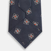 View 3 of product The Turnbull & Asser Grey Square Overlay Silk Tie features a refined chevron pattern with gray square motifs and subtle red accents, expertly handmade for formal occasions. Presented neatly rolled on a white background.