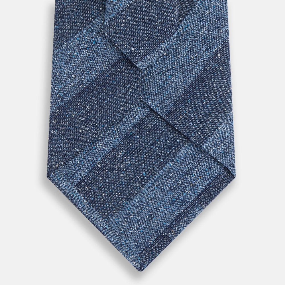 The Turnbull & Asser Blue Block Stripe Silk Tie, featuring a refined striped pattern, is elegantly showcased rolled up against a plain white background.