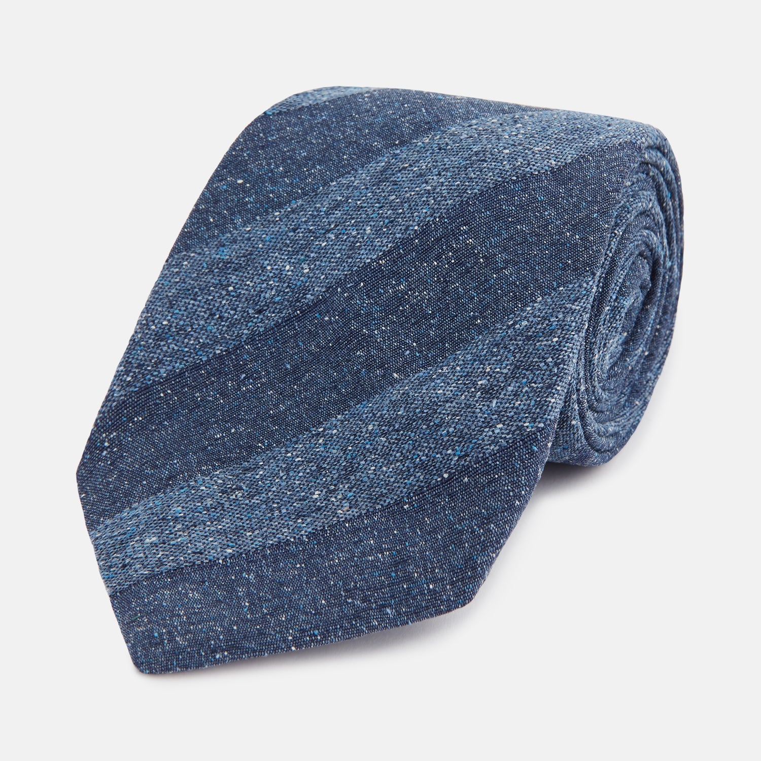 View 1 of product The Turnbull & Asser Blue Block Stripe Silk Tie, featuring a refined striped pattern, is elegantly showcased rolled up against a plain white background.