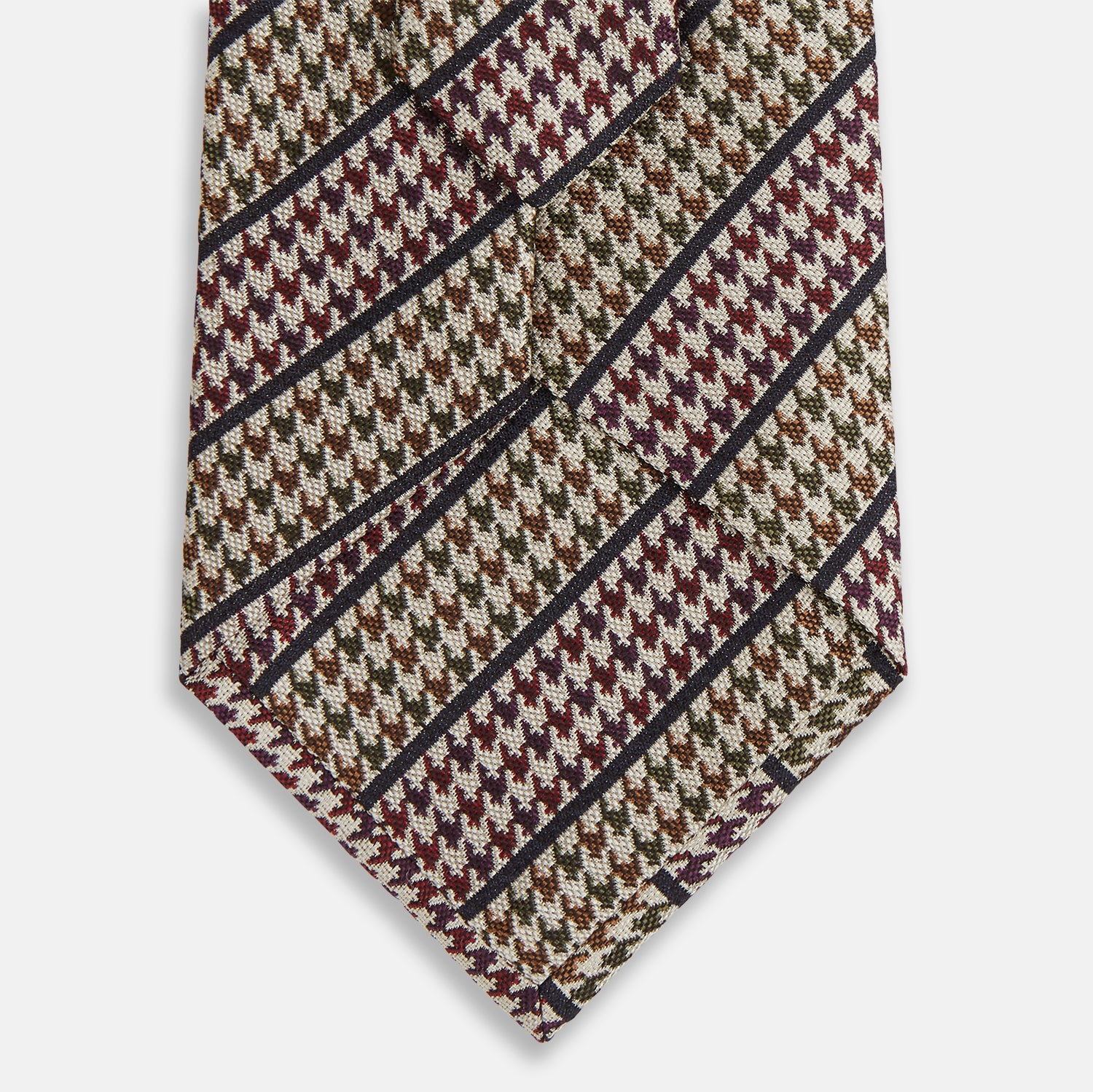 View 3 of product The Turnbull & Asser Brown Puppytooth Stripe Silk Tie features a brown, burgundy, and cream houndstooth pattern with black and white diagonal stripes—ideal for pairing with Turnbull & Asser shirts.