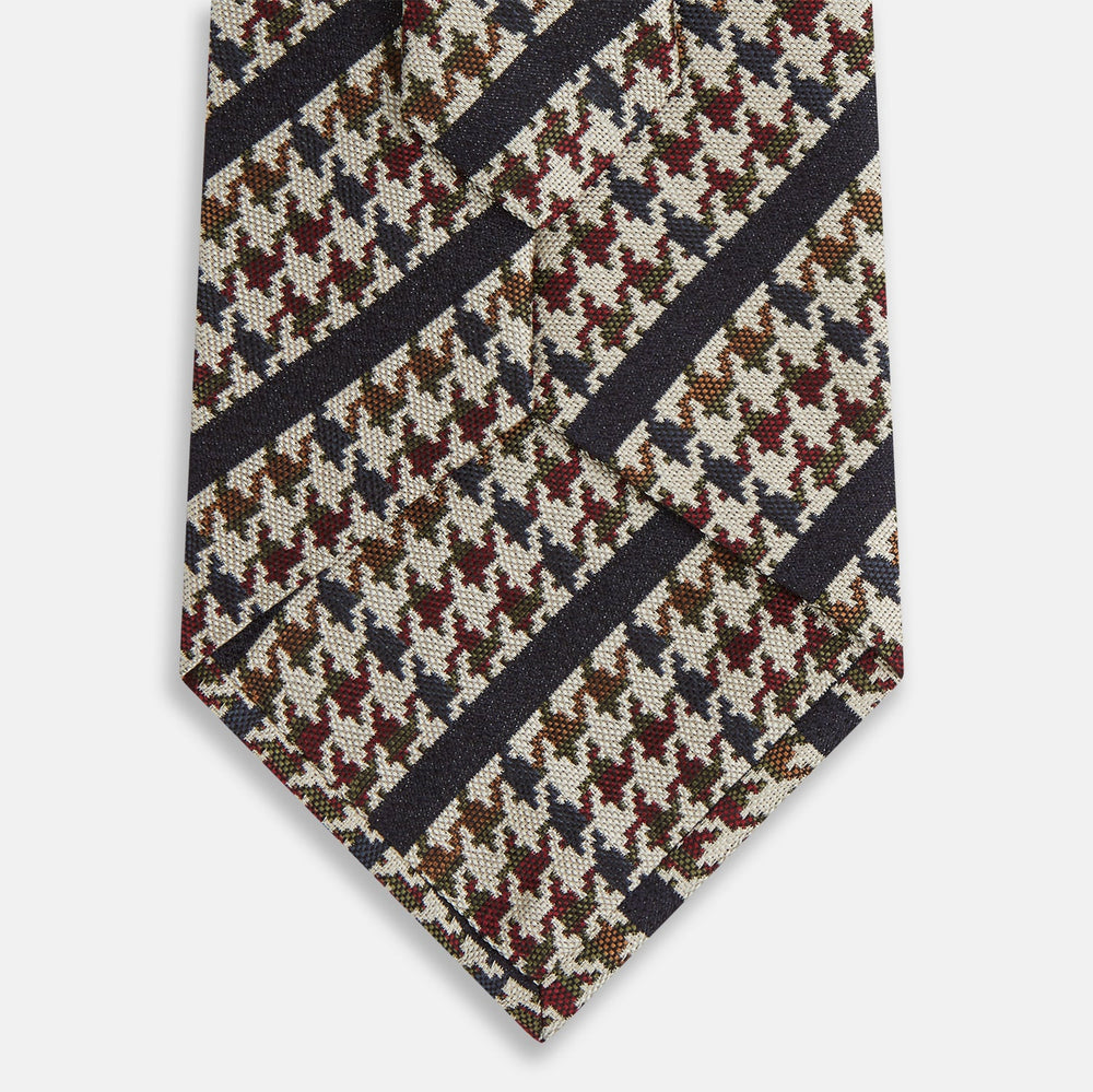 The Turnbull & Asser Brown Houndstooth Stripe Silk Tie features a houndstooth pattern with diagonal stripes, crafted from silk for a refined finish—ideal to pair with Turnbull & Asser shirts.