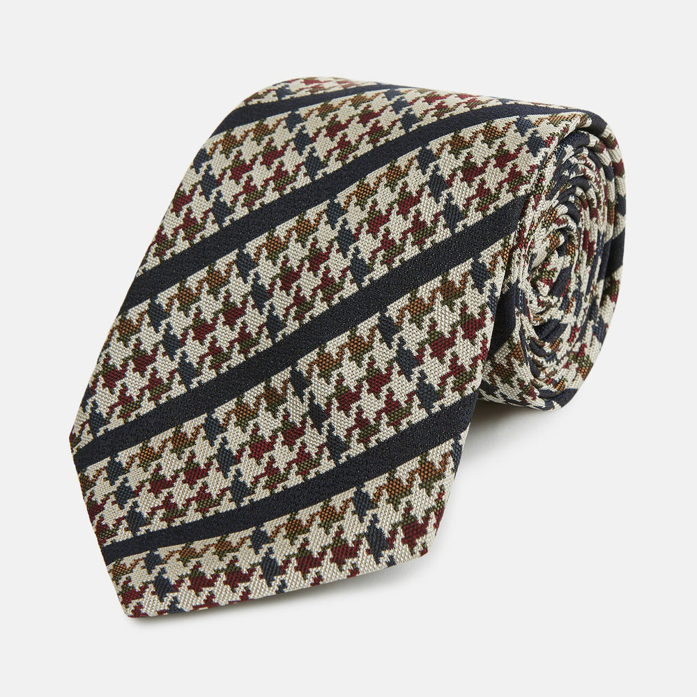 The Turnbull & Asser Brown Houndstooth Stripe Silk Tie features a houndstooth pattern with diagonal stripes, crafted from silk for a refined finish—ideal to pair with Turnbull & Asser shirts.