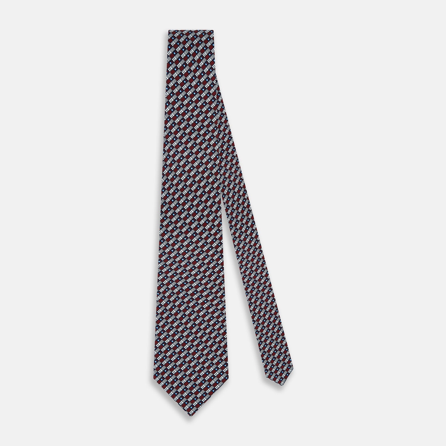 View 2 of product The Turnbull & Asser UK TIES 9.5CM GEOMETRIC RECTANGLES RED is an English silk tie with small red, navy blue, and white rectangles and dots on a white background.