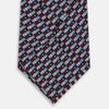 View 3 of product The Turnbull & Asser UK TIES 9.5CM GEOMETRIC RECTANGLES RED is an English silk tie with small red, navy blue, and white rectangles and dots on a white background.
