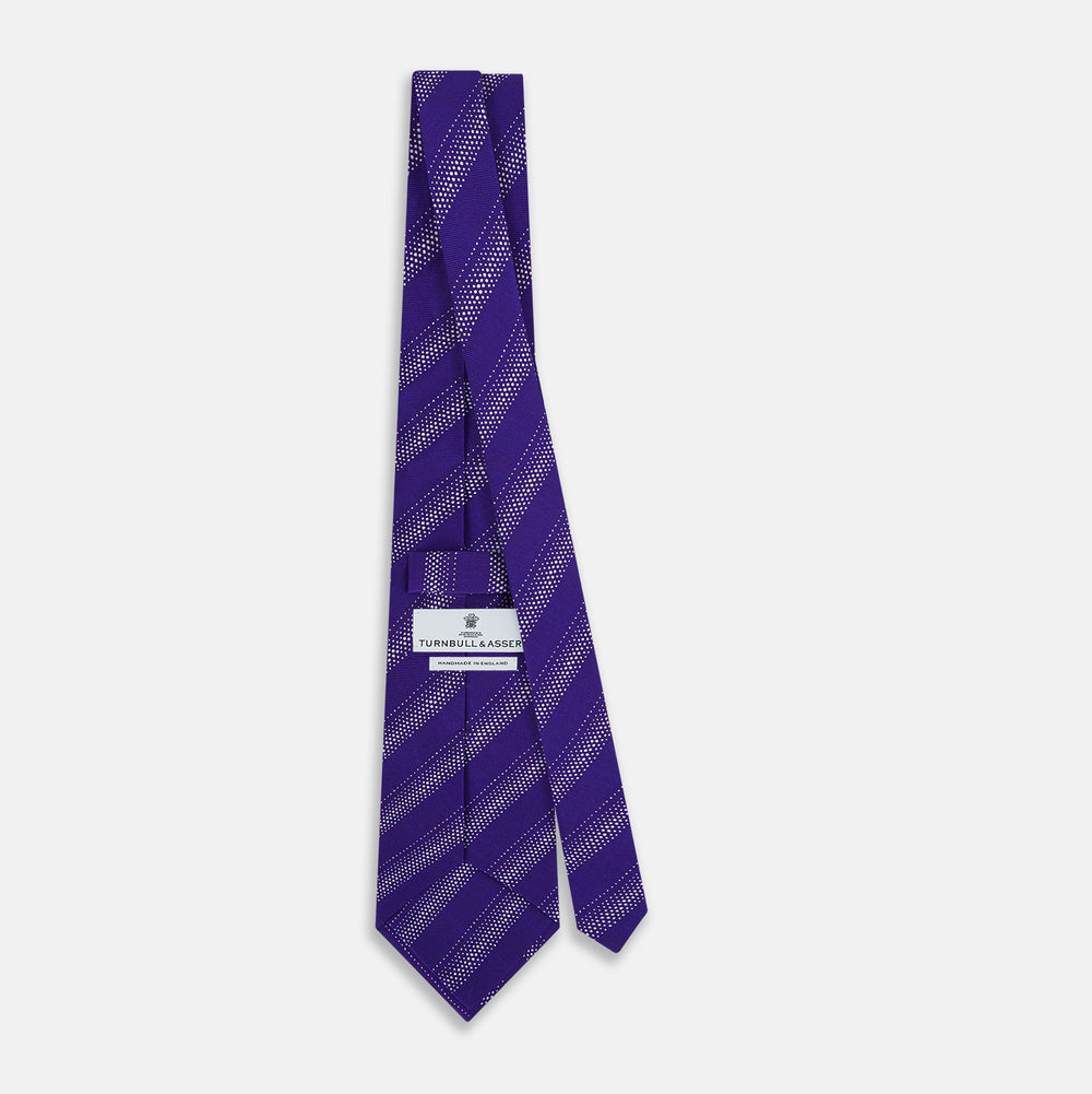The Purple Dotted Stripe Printed Silk Tie by Turnbull & Asser UK features diagonal light purple dotted stripes on silk, displayed against a white background.