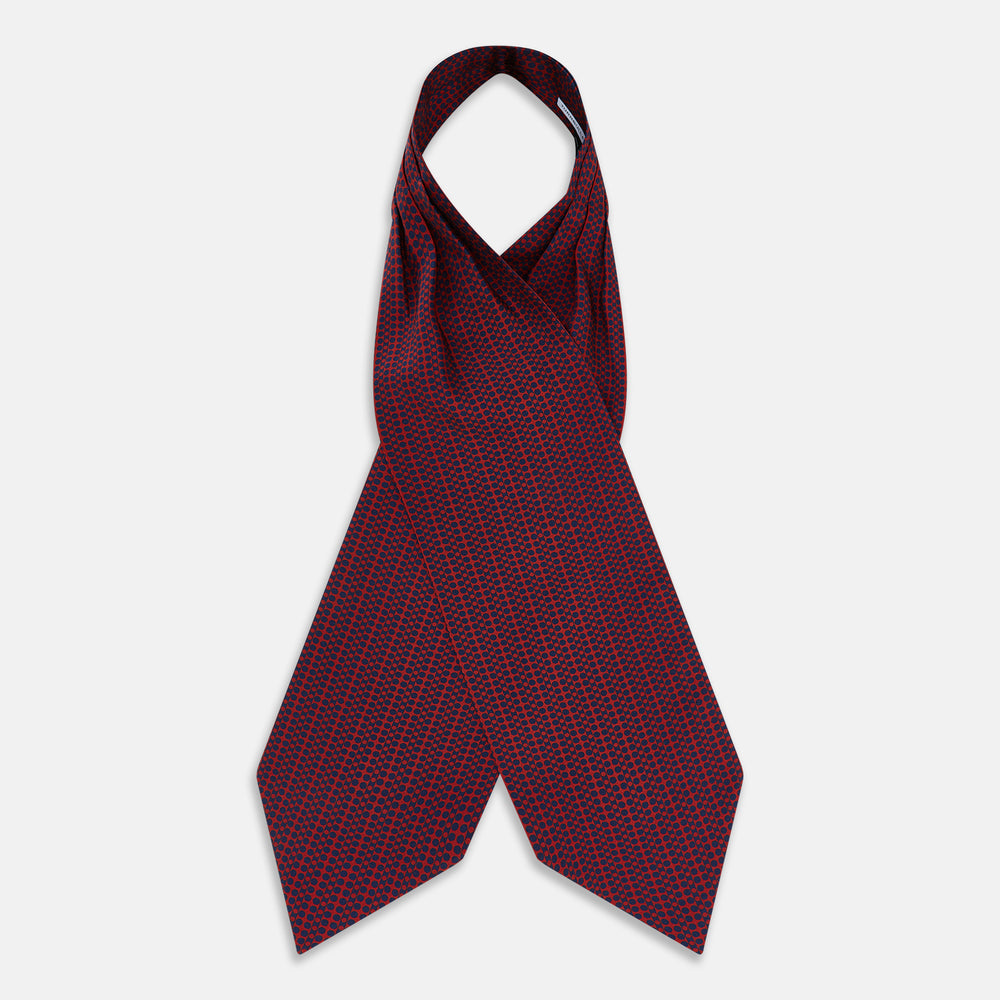 The Red Micro-Dot Bar Printed Silk Cravat from Turnbull & Asser UK features a geometric red and navy micro-dot pattern—a refined accessory inspired by classic British style, perfect for elegant weddings.