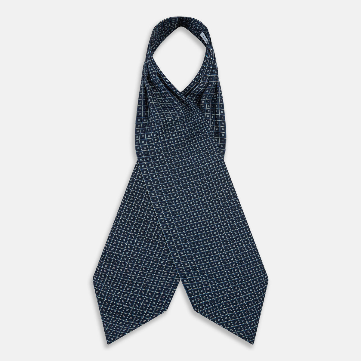 View 2 of product A folded Geometric Navy Quatrefoil Motif Ascot Tie in Silk, featuring a navy ground with a white grid pattern and small quatrefoil motifs in each square.