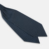 View 3 of product A folded Geometric Navy Quatrefoil Motif Ascot Tie in Silk, featuring a navy ground with a white grid pattern and small quatrefoil motifs in each square.