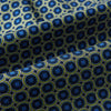 View 4 of product Close-up of Turnbull & Asser UK's Navy Interlocking Circle Foulard Silk Cravat, featuring a geometric pattern of yellow and blue circles and squares. Subtle folds add texture—ideal as a refined accessory inspired by classic British style.