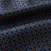 View 4 of product The Turnbull & Asser UK Midnight Blue Contrasting Rosette Medallion Printed Silk Cravat features a grid of small red, yellow, and blue floral patterns on textured silk—evoking classic British style.