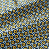 View 4 of product A close-up of Turnbull & Asser UK's Citrus Yellow Abstract Quatrefoil Foulard Printed Silk Cravat shows a gently folded fabric with blue, yellow, and white geometric patterns for a classic British look.