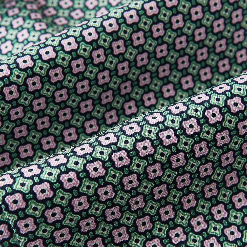 Close-up of the Kelly Green and Pink Abstract Quatrefoil Foulard Printed Silk Cravat by Turnbull & Asser UK, showcasing its intricate geometric floral pattern—ideal for a refined British style accessory.