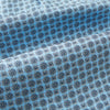 View 4 of product Close-up of Turnbull & Asser UK's Pale Blue Floral Trellis Silk Cravat, featuring light blue silk with a repeating dark blue geometric floral trellis pattern. The fabric appears slightly folded, highlighting its textured, decorative look.
