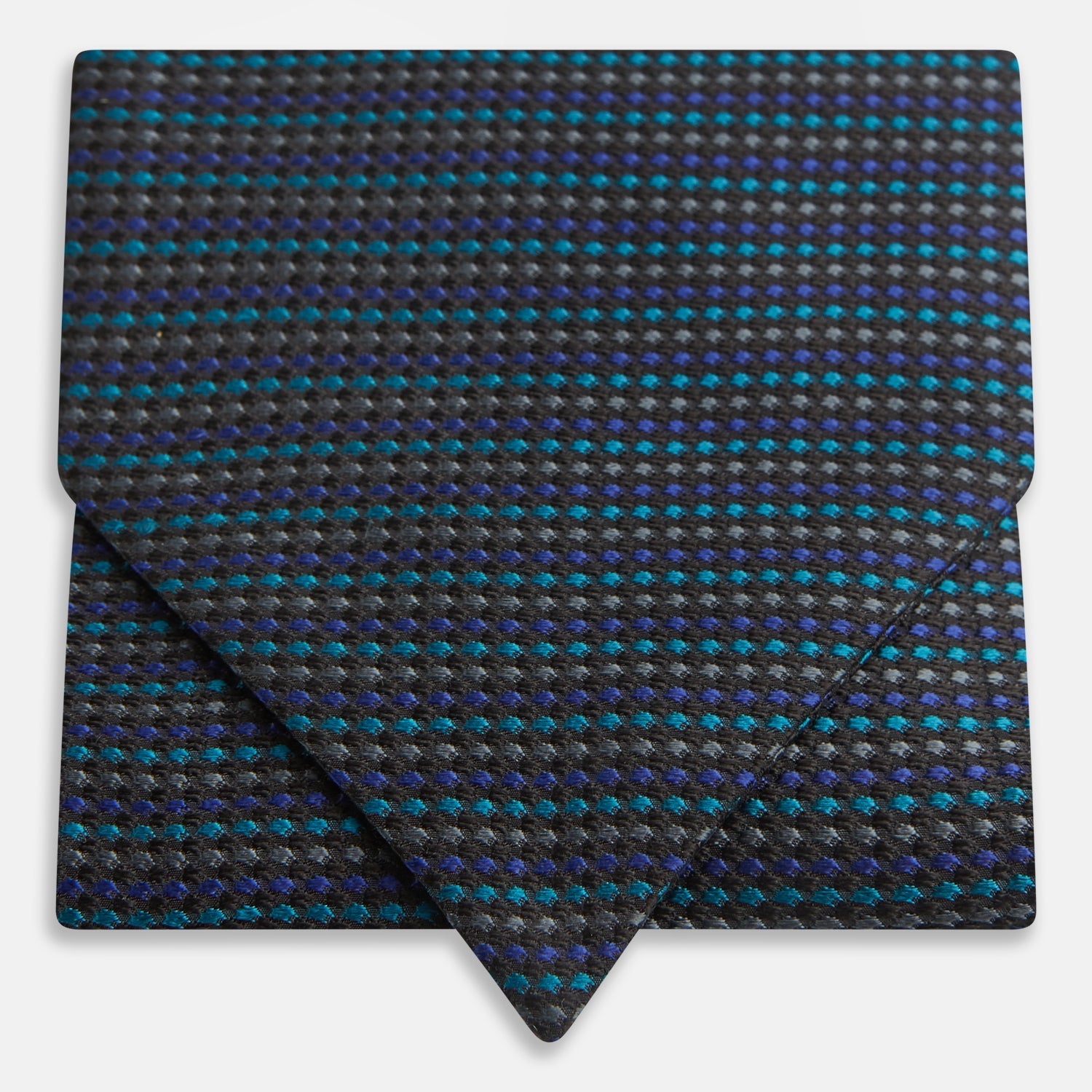 View 1 of product Turnbull & Asser's Navy Multi Silk Cravat pairs perfectly with a folded pocket square featuring a grid of small blue and black dots on a dark background—an ideal touch for adding flair to your next formal outfit.