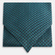 The Turquoise Geometric Silk Cravat by Turnbull & Asser features a striking teal and black pattern—perfect for those who appreciate bold, handmade neckwear with geometric flair.