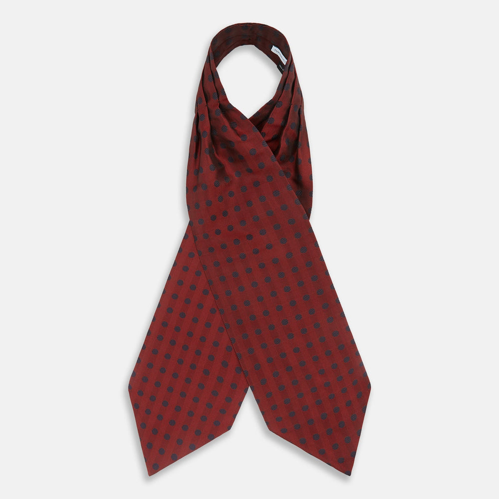 The Turnbull & Asser Red Dot Silk Cravat is a red silk accessory with evenly spaced dark blue polka dots—neatly folded for a sharp finish and perfect for pairing with your favorite handmade neckwear.