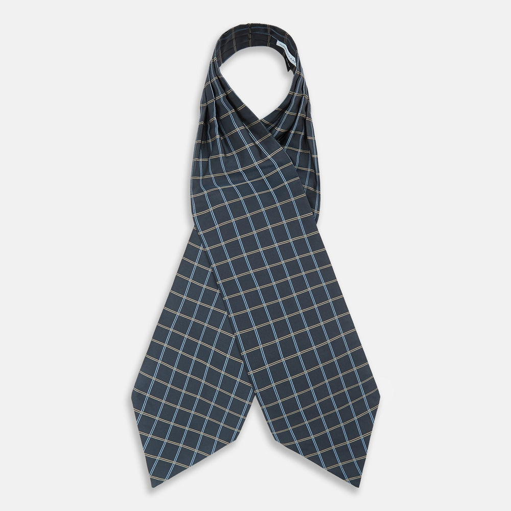 The Navy Fine Double Check Silk Cravat by Turnbull & Asser features a grid pattern in light blue and white lines—an elegant formal men's accessory, neatly folded with the pointed end at the bottom.