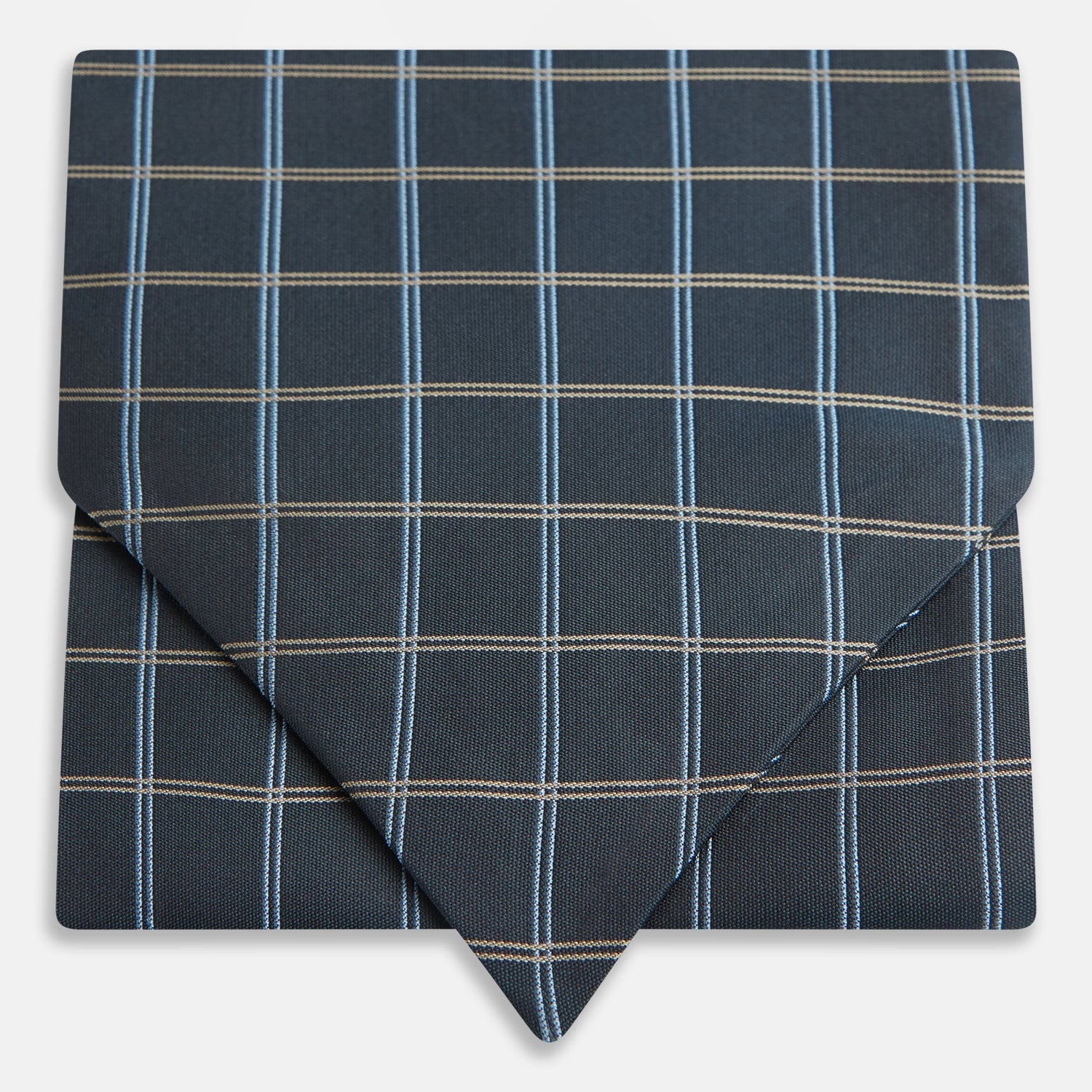 View 1 of product The Navy Fine Double Check Silk Cravat by Turnbull & Asser features a grid pattern in light blue and white lines—an elegant formal men's accessory, neatly folded with the pointed end at the bottom.