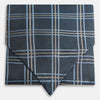 View 1 of product The Turnbull & Asser Navy Triple Check Silk Cravat features a classic navy, white, and light blue plaid design—perfect for adding elegance to any outfit. Shown neatly folded on a white background.